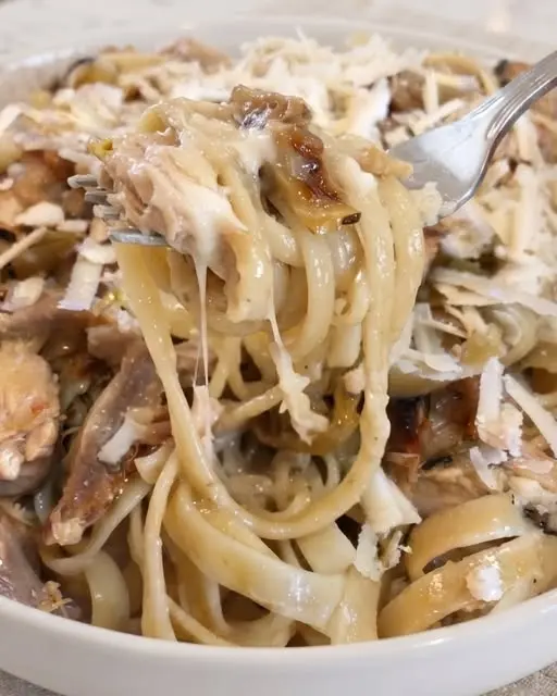 Honey garlic butter chicken pasta served in a bowl, garnished with fresh parsley and red pepper flakes.