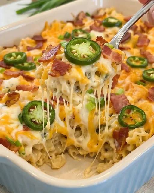 Finished jalapeño popper chicken pasta casserole served in a dish with garnishes