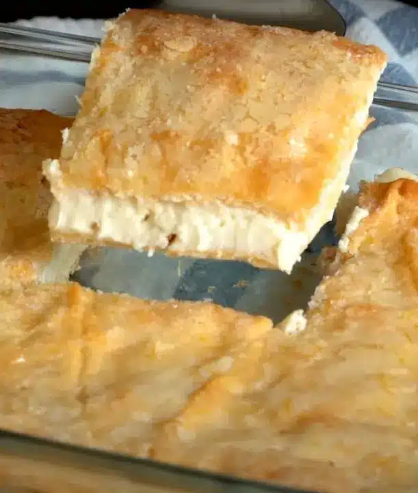 The finished lemon cream cheese squares cut into perfect portions and dusted with powdered sugar.