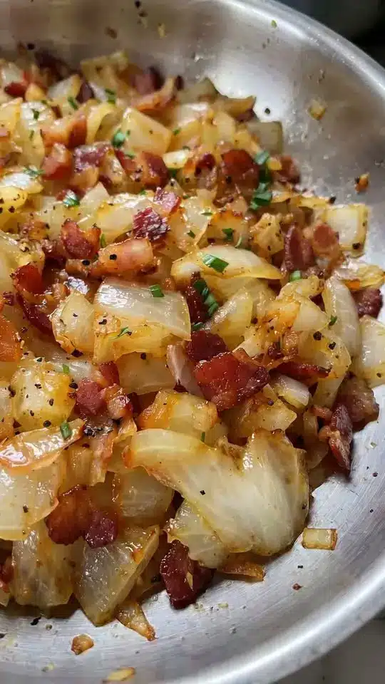 A serving of loaded cheesy potato casserole on a plate showing the creamy interior and crispy topping