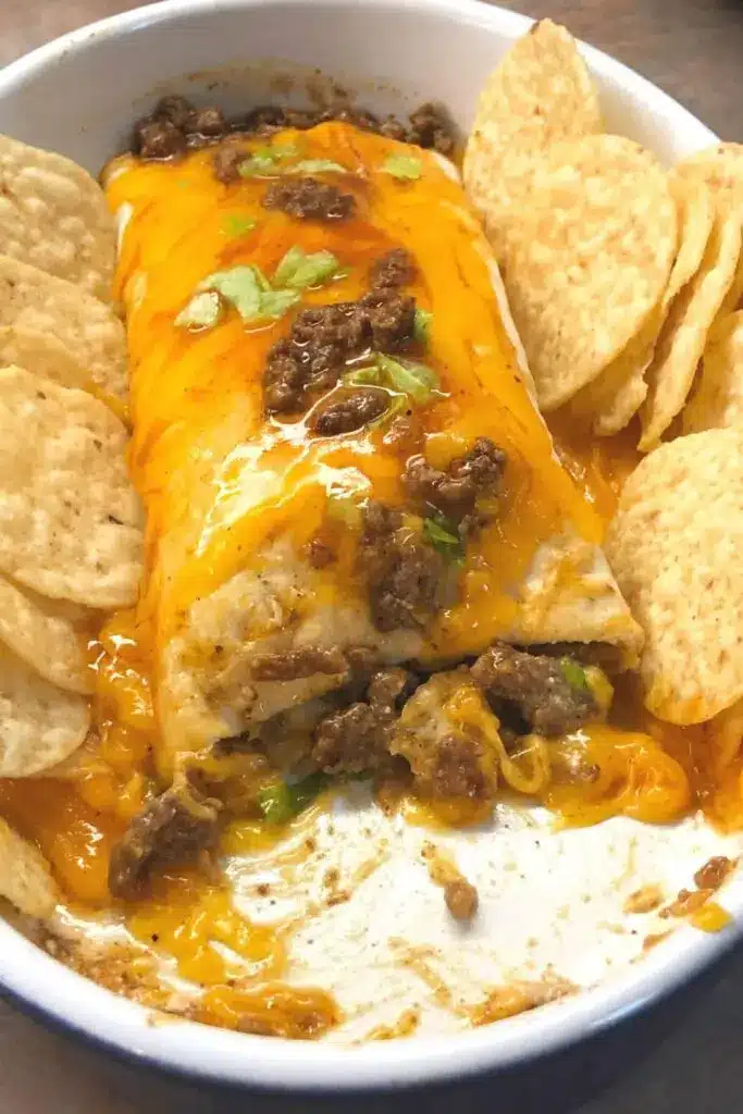 Finished mexican beef cheese sanchiladas garnished with cilantro and sour cream