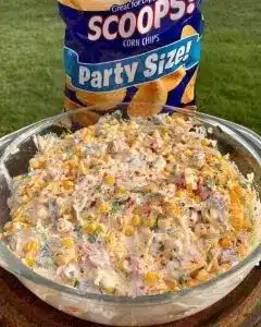 A close up view of the mexicorn and rotel dip showing the textures of corn, peppers, and melted-looking cheese.