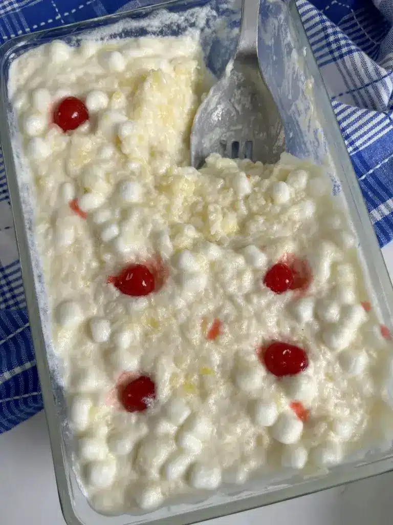 A close up of creamy glorified rice with pineapple and marshmallows.