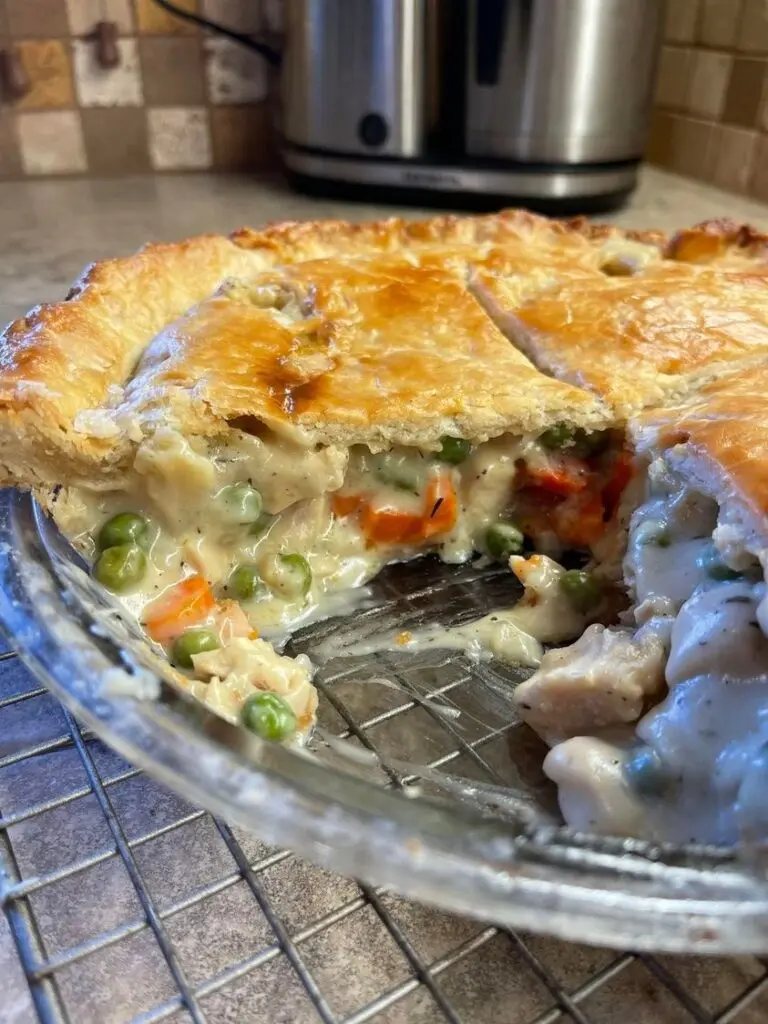 A serving of chicken pot pie casserole with creamy filling and a golden biscuit