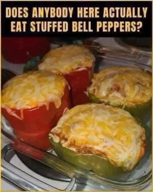 A single beef stuffed pepper served on a white plate with fresh parsley garnish.