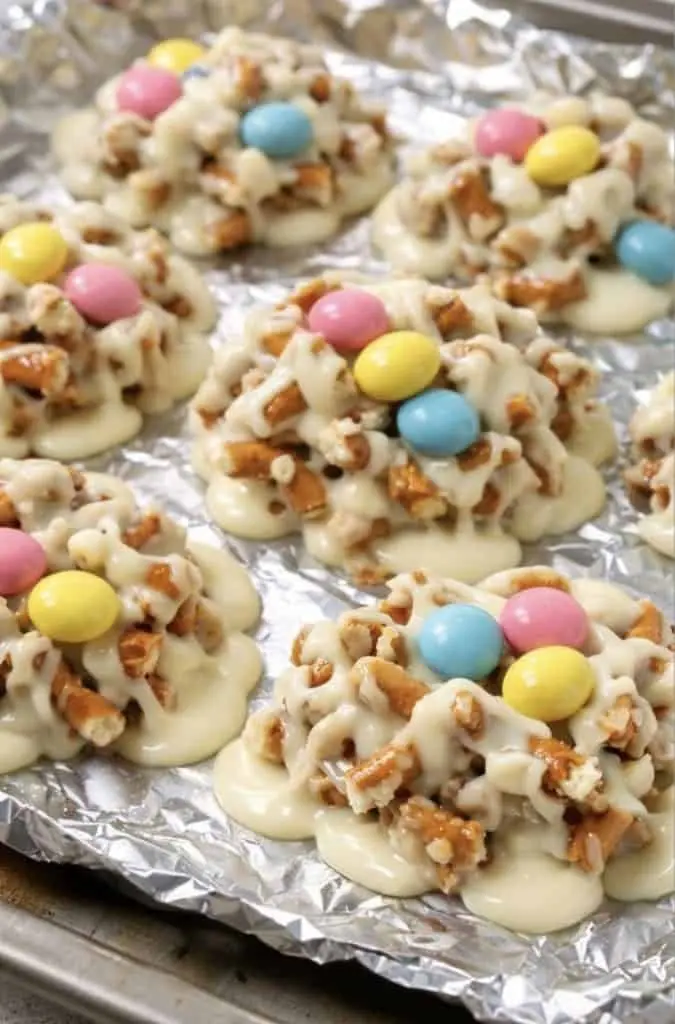 A festive display of slow cooker Easter candy in a gift box with pastel decorations.
