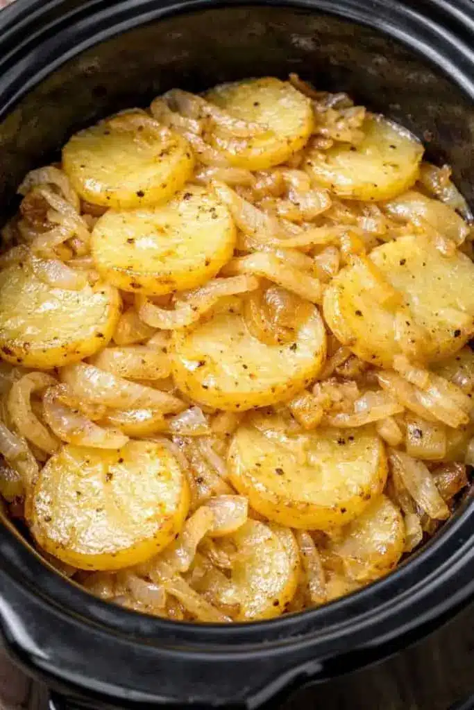 Served portion of potato onion bake on a white plate garnished with fresh parsley