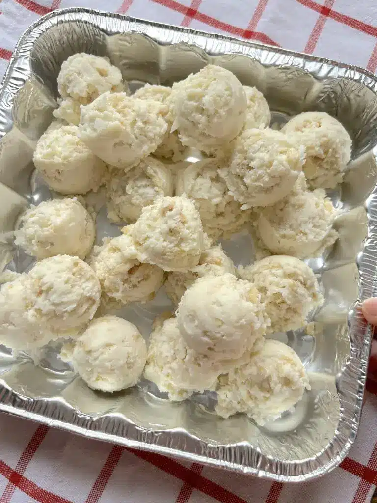 A finished slow cooker snowball cake served on a platter, showcasing the soft white crumb