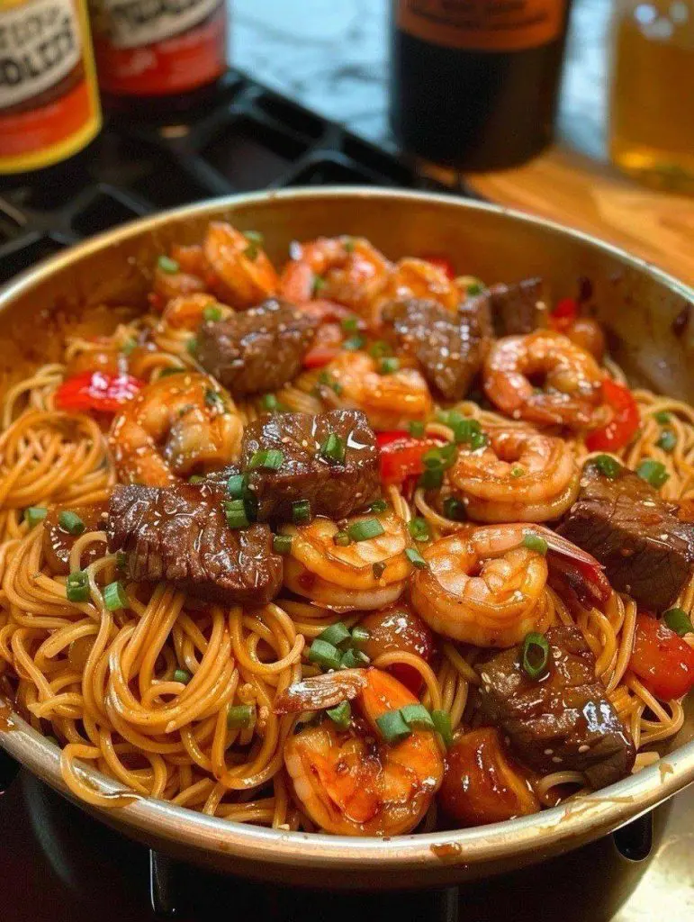 A bowl of steak and shrimp teriyaki noodles ready to be served