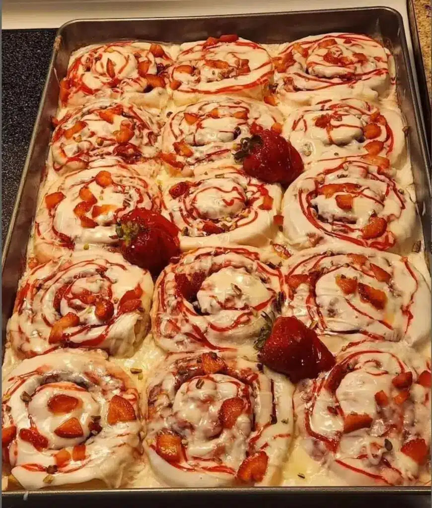 Close up of a strawberry cream cheese roll showing the swirl and fruit
