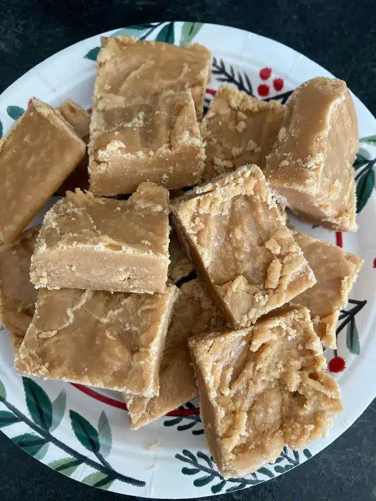 Squares of Scottish tablet served on a plate with a cup of tea