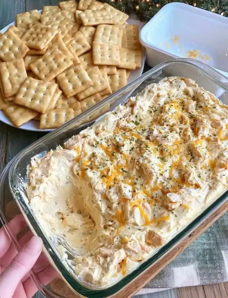 A close up shot of Wisconsin cheese spread on a cracker with a garnish of chives
